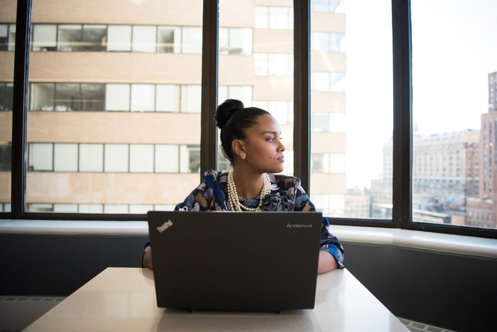 kobieta w pracy siedząca przy biurku i laptopie