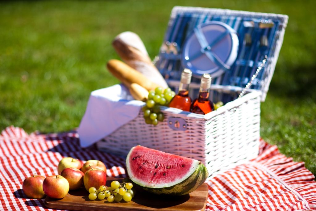Biały kosz piknikowy oraz deska z owocami